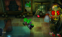 Luigi vacuums Biff Atlas in the Rec Room of Luigi's Mansion for the Nintendo 3DS.