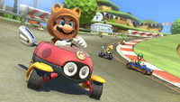 Tanooki Mario riding a Biddybuggy in Mario Kart 8