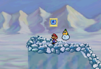 Mario standing next to the Super Block in Shiver Mountain in Paper Mario.