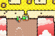 A Green Yoshi in its helicopter form flying toward a Yoshi Block depicting its face in Go! Go! Morphing! in Yoshi's Island: Super Mario Advance 3