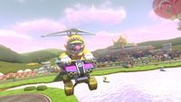 Wario glides at N64 Royal Raceway, with his Standard ATV equipped with the Gold Tires.