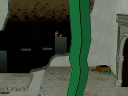 Mario next to the Star Piece in the background of the west entrance of Rogueport Sewers