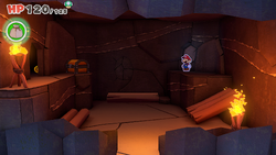 Mario standing near a stone slab containing a 100-Coin in Breezy Tunnel of The Origami King.