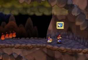 Mario standing next to the first Super Block in Mt. Lavalava in Paper Mario.