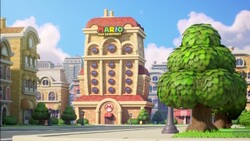 Intro cutscene screenshot of the Mario Toy Company's main building in Mario vs. Donkey Kong (Nintendo Switch)