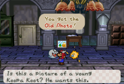 Mario receiveing an Old Photo from Franky in the Boo's Mansion of Paper Mario.