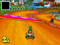 Toad near a Boost Pad in Yoshi Falls from Mario Kart DS.