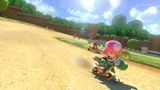 Toadette rides on the Yoshi Bike.