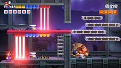 Screenshot of Twilight City level 8-DK from the Nintendo Switch version of Mario vs. Donkey Kong