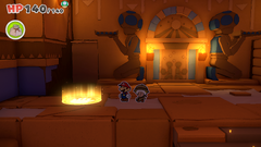 Mario standing on a patch of sand containing a Small Bag of Confetti in Temple of Shrooms of The Origami King.