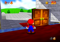 The black room of death glitch from Super Mario 64. Mario is behind the door.