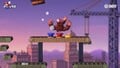Donkey Kong takes a hit from one of the large barrels