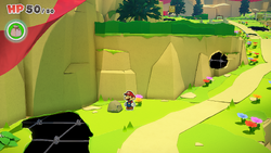 Mario standing near a rock containing a Small Bag of Confetti in Picnic Road of The Origami King.