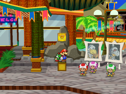 Mario next to the Shine Sprite in the arena of Glitzville in Paper Mario: The Thousand-Year Door.