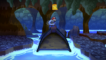 Mario next to the Shine Sprite near the entrance of the Pirate's Grotto in the remake of the Paper Mario: The Thousand-Year Door for the Nintendo Switch.