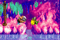 Kiddy Kong holding a Steel Barrel toward Koin at the end of Ripcurl Reef in the Game Boy Advance version of Donkey Kong Country 3