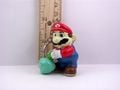 This promo keychain for Super Mario Bros. 2 features Mario pulling up a turnip