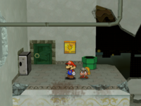 Mario next to the Shine Sprite to the left of the west entrance of Rogueport Sewers in Paper Mario: The Thousand-Year Door.