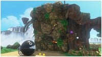 A screenshot of Super Mario Odyssey, featuring the Cascade Kingdom's Great Barrier, aka a really big setpiece stone wall