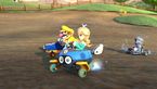 Rosalina, Wario, and Metal Mario race on the track
