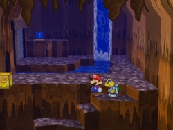 Screenshot of Mario at a hidden ? Block location in Pirate's Grotto, in Paper Mario: The Thousand-Year Door.