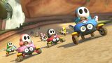 Many different colored Shy Guys racing in the Biddybuggy kart