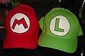 Green and red hats with Mario's and Luigi's symbols on them