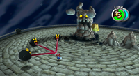 Mario, swinging around some Bomb Boos, in the battle against Bouldergeist