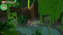 Mario standing near a flower bush containing a Healing Heart in Spring of Jungle Mist of The Origami King.
