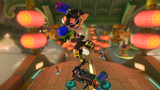 Inkling Boy performing a trick. Baby Peach and Roy Koopa are seen in the background on Dragon Driftway