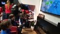 The Nintendo Switch being demonstrated in TV mode in a living room setting.
