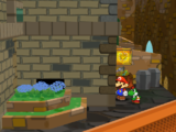 Mario next to the Shine Sprite in the backyard of the rightmost house in the west Rogueport