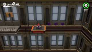 To the right of a moving platform in the New Donk City Hall Interior.