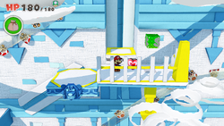 Mario standing near a Healing Heart in Sea Tower of The Origami King.