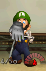 Luigi collecting Mario's Glove in the game Luigi's Mansion.