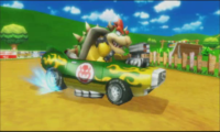 Snapshot of Bowser drifting on Moo Moo Meadows in the Mario Kart Wii Demo Movie.