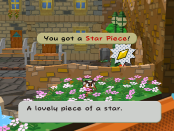 Mario getting the Star Piece behind the low wall in the right part of the Rogueport west scene in Paper Mario: The Thousand-Year Door.
