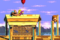 Dixie Kong and Kiddy Kong find a Red Balloon over a roof just before the Star Barrel in the Game Boy Advance remake of Donkey Kong Country 3