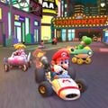 Mario, Peach, Yoshi, Shy Guy, and Donkey Kong driving past the finish line