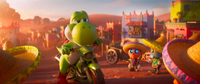 Yoshi on Luigi's motorcycle surrounded by Tostarenans in The Super Mario Galaxy Movie.