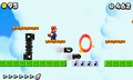 Mario running towards a Red Ring, away from Bullet Bills.