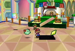 Mario finding a Star Piece in front of the green station in Shy Guy's Toy Box in Paper Mario