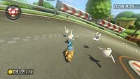 Little birds standing on the ground and flying away from Larry in Mario Kart 8.