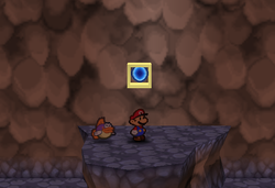 Mario standing next to the second Super Block in Mt. Lavalava in Paper Mario.