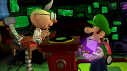 Luigi about to place the second Dark Moon piece on the scrubbing device in Luigi's Mansion 2 HD.