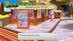 Mario getting the Star Piece behind the telephone booth of Glitzville in the remake of the Paper Mario: The Thousand-Year Door for the Nintendo Switch.