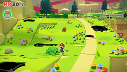 Mario standing near a bush containing a Small Bag of Confetti in Picnic Road of The Origami King.