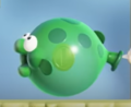 A green Bloomp with a coin inside