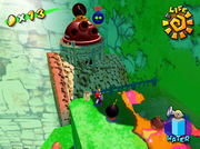 Mario confronting the Monty Mole inside a cannon on top of the cork plugging up the waterfall.
