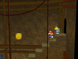 Mario next to the Shine Sprite over the stairs